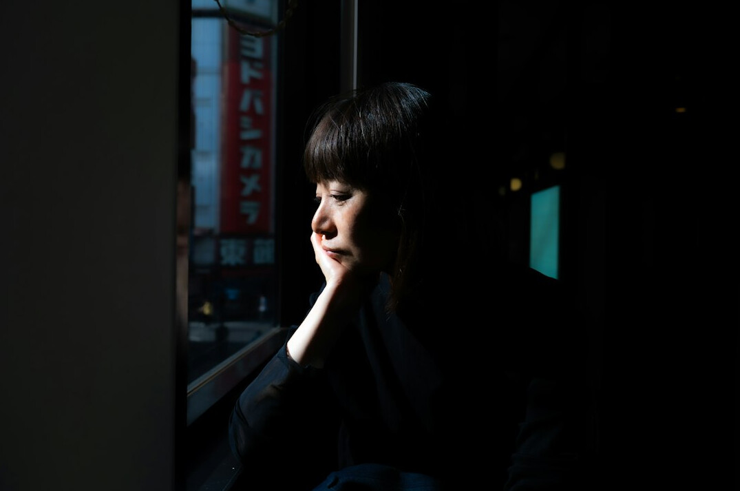 person reflecting by window