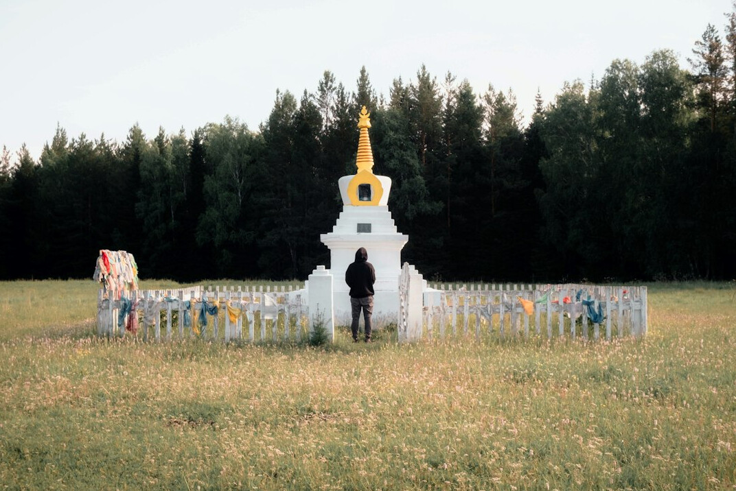 person meditating outdoors